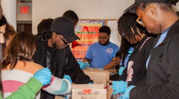 Youth Action 2024 MLK Day of Service group packing care items for the unhoused