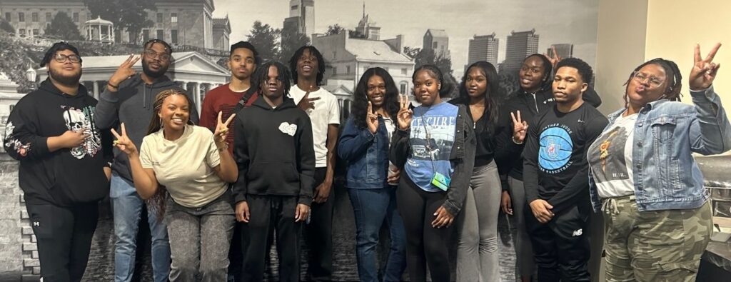 Youth Action students, facilitators, friends, and families attending a fun outing at Dave & Busters