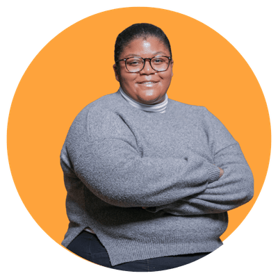 Person in gray sweater, orange background