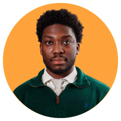 Rayshawn Johnson wearing a green quarter zip and a white button up