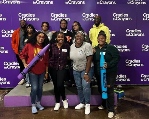 group of youth action students, parents, and facilitators at Cradles to Crayons